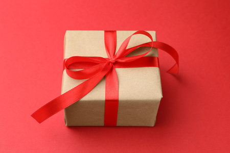 Beautiful gift box on red background, closeupの写真素材