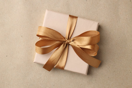 Decorated gift on kraft paper background, top viewの写真素材