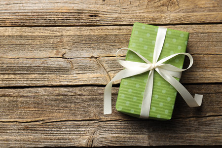 Decorated Christmas gift on wooden background, top view. Space for textの写真素材