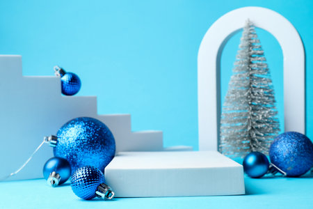 Empty podium and Christmas decor on light blue background, closeup. Space for textの写真素材