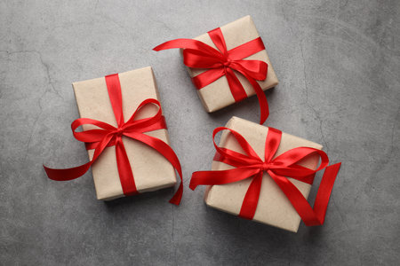 Decorated Christmas gifts on gray background, flat layの写真素材