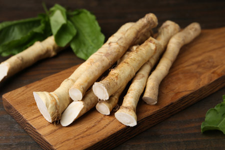 Fresh raw horseradish roots and leaves on wooden table, closeupの写真素材