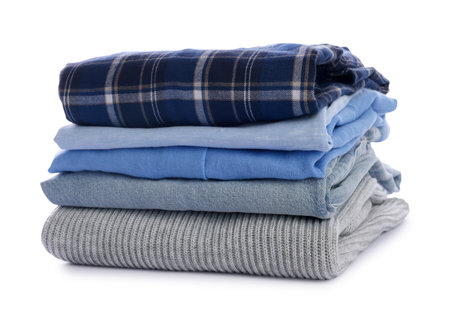 Stack of clean folded clothes isolated on whiteの写真素材