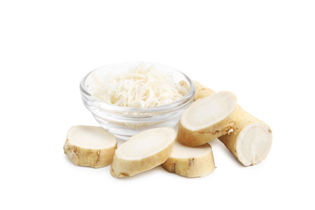 Grated horseradish and cut root isolated on whiteの写真素材
