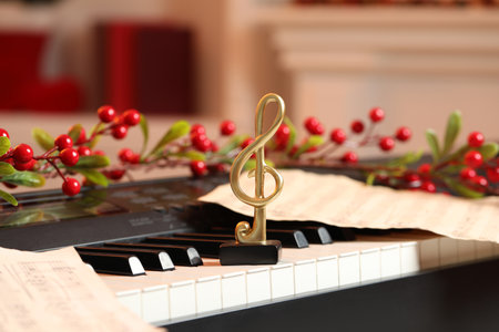 Golden treble clef, music sheets and Christmas decor on piano indoors, closeupの写真素材