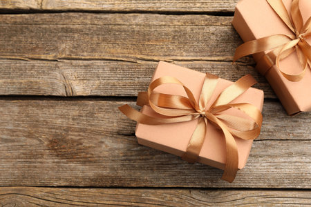 Beautiful gift boxes on wooden background, flat lay. Space for textの写真素材