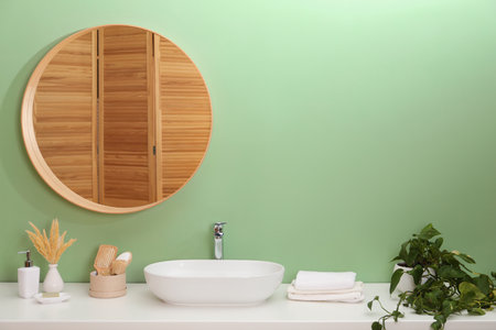 Stylish bathroom interior with mirror, vessel sink and houseplant, space for textの写真素材