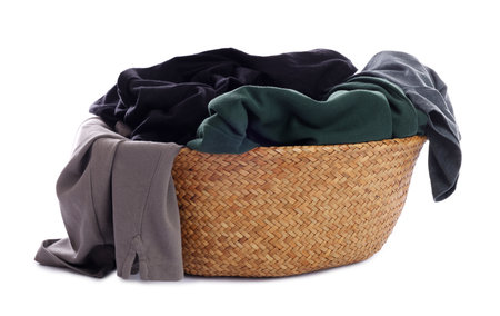 Wicker basket with laundry isolated on whiteの写真素材