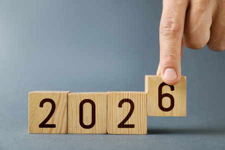 Man putting cube with number 6 on gray background, closeupの写真素材