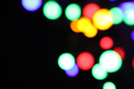 Bright lights on dark background, space for text. Bokeh effect