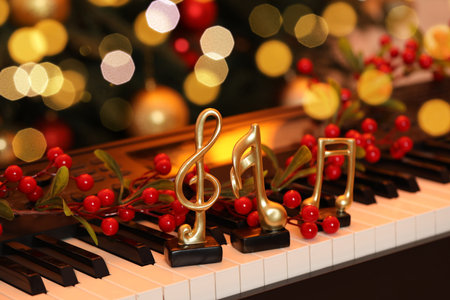 Golden music notes and Christmas decor on piano indoors, closeupの写真素材