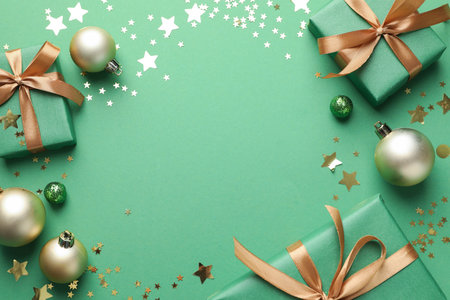 Beautiful Christmas composition with gifts and decor on green background, flat lay. Space for textの写真素材