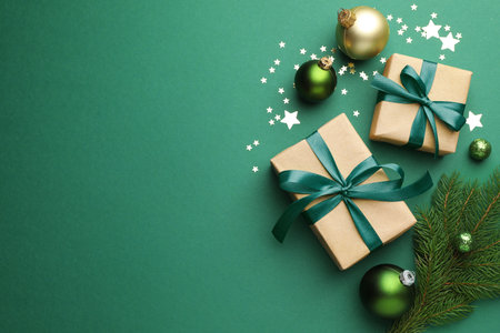 Beautiful Christmas composition with gifts and decor on green background, flat lay. Space for textの写真素材