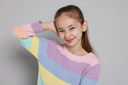 Portrait of cute girl on gray backgroundの写真素材