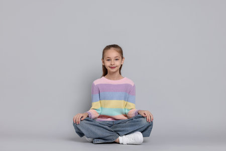 Portrait of cute girl on gray backgroundの写真素材