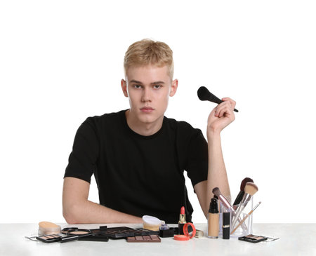 Makeup artist with tools and cosmetic products at table on white backgroundの写真素材