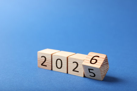 New year. Flipping cube with number 5 and 6 to make 2026 on blue background, closeupの写真素材