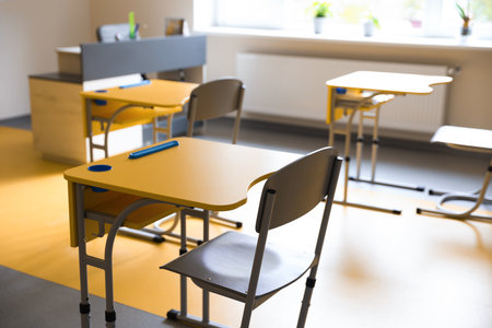 Yellow desks and chairs in classroom at schoolの写真素材
