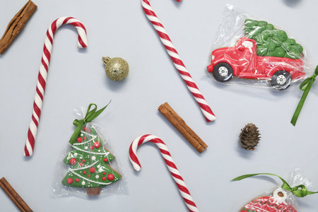 Flat lay composition with candy canes on light background. Christmas treat