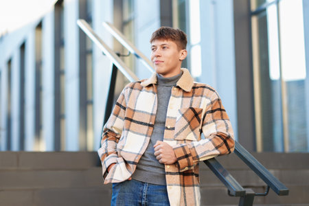 Handsome man in shirt near railings outdoorsの写真素材