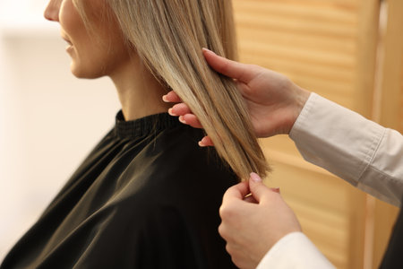 Hairdresser working with her client in salon, closeupの写真素材