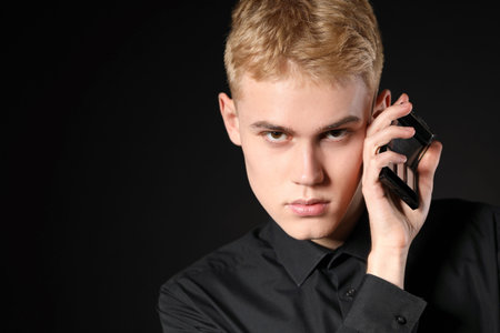 Makeup artist with eyeshadow palette on black backgroundの写真素材