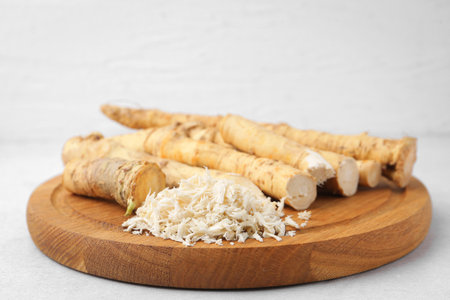 Whole and gratified horseradish roots on light gray table, closeupの写真素材