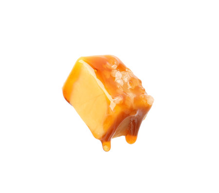 Tasty candy with salt and caramel sauce isolated on whiteの写真素材