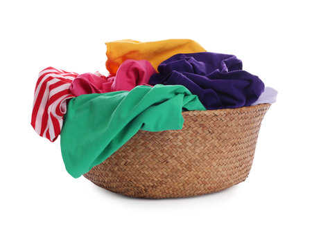 Wicker basket with laundry isolated on whiteの写真素材