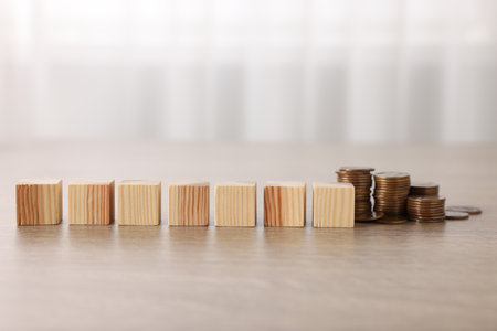 Alimony. Blank cubes and coins on wooden tableの写真素材
