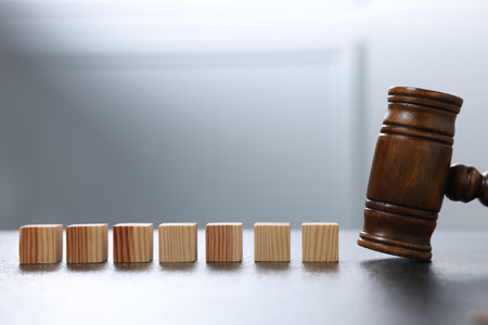 Alimony. Blank cubes and gavel on dark table, closeupの写真素材