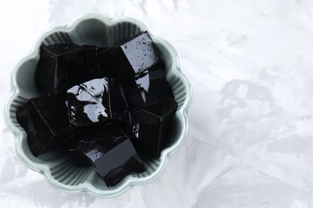 Tasty herbal jelly on light table, top view. Space for textの写真素材