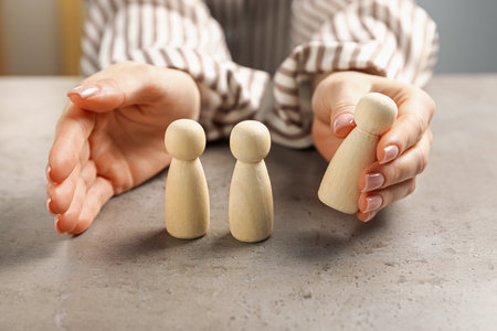 Woman with human figures at light table, closeupの写真素材