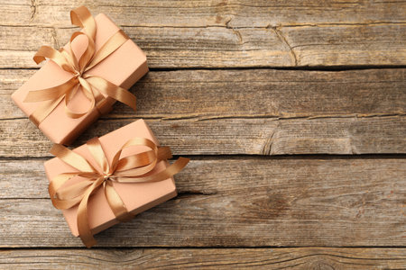 Beautiful gift boxes on wooden background, flat lay. Space for textの写真素材
