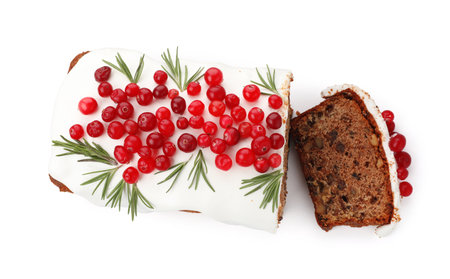 Tasty Christmas cake with icing, cranberries and rosemary isolated on white, top viewの写真素材