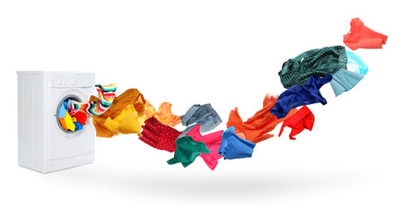 Washing machine and flying laundry on white backgroundの写真素材