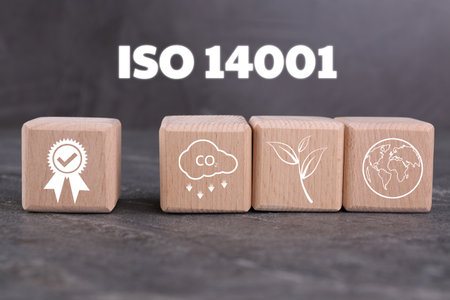 ISO 14001 Environmental management systems. Wooden cubes with different icons on gray tableの写真素材