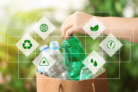 Woman putting garbage into paper bag on blurred background, closeup. Scheme with recycling symbol and different icons. Ecology and clean environmentの写真素材