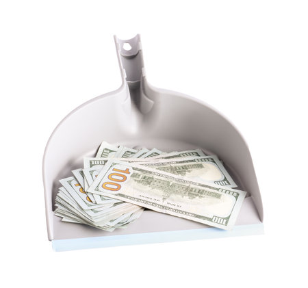 Dustpan with dollar banknotes isolated on whiteの写真素材