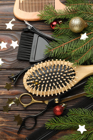 Different hairdresser's tools and Christmas decor on wooden table, flat layの写真素材