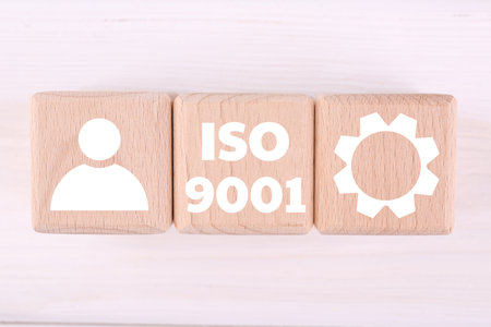 ISO 9001 Quality management systems. Wooden cubes with different icons on white background, top viewの写真素材