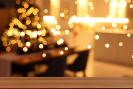 Empty wooden table against blurred room with Christmas tree, bokeh lights. Space for designの写真素材