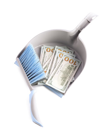 Dustpan with broom and dollar banknotes isolated on white, top viewの写真素材