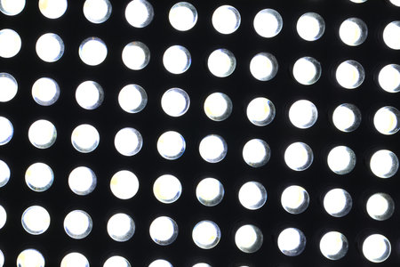 Modern illuminated LED lamp as background, closeup