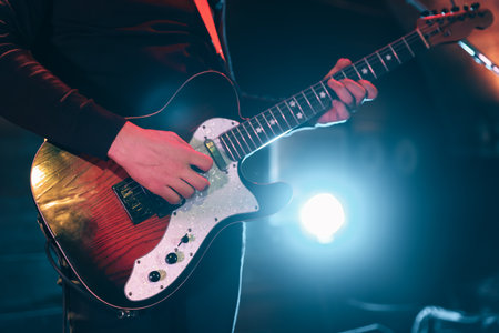 Man playing electric guitar on stage, closeupの写真素材