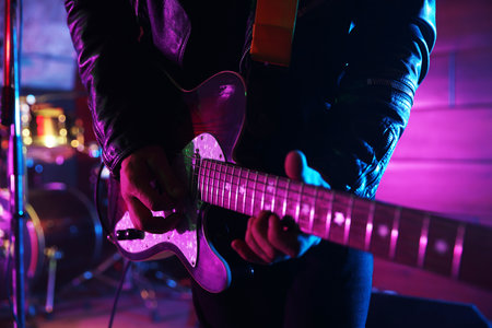 Man playing electric guitar on stage, closeupの写真素材