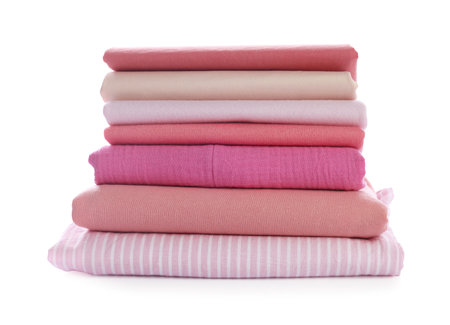 Stack of clean pink clothes isolated on whiteの写真素材