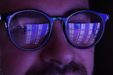 Man wearing glasses with reflection on black background, closeupの写真素材