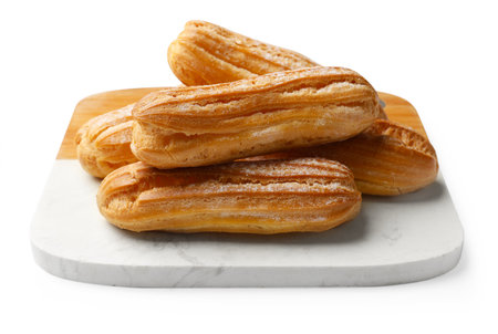 Tasty eclairs with powdered sugar isolated on white