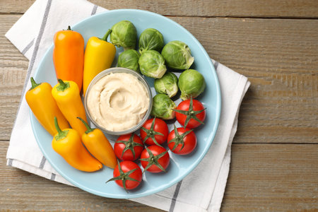 Different fresh vegetables and sauce on wooden table, top viewの写真素材